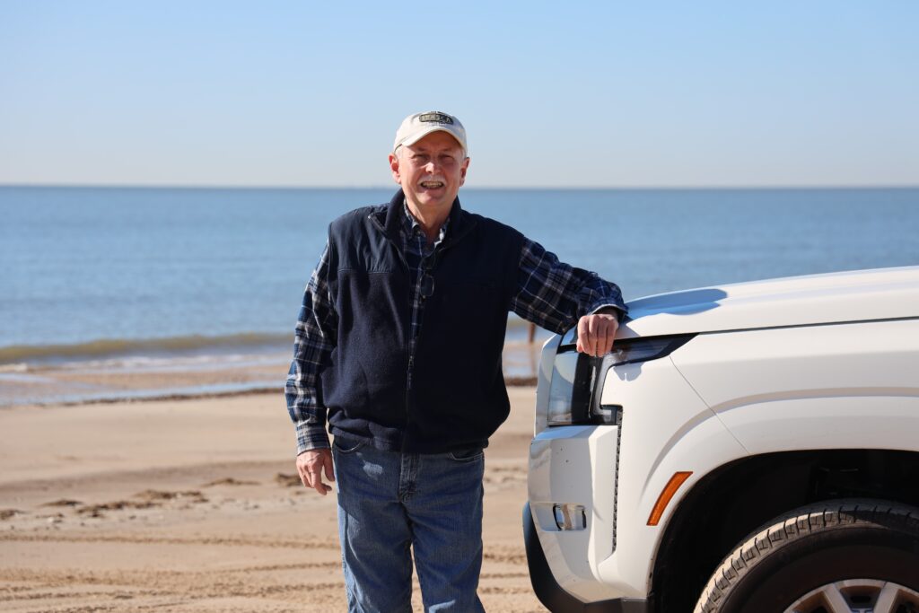 Skip standing by our truck on the beach at Sea Rim State Park, just steps from this Gulf Coast state park campground