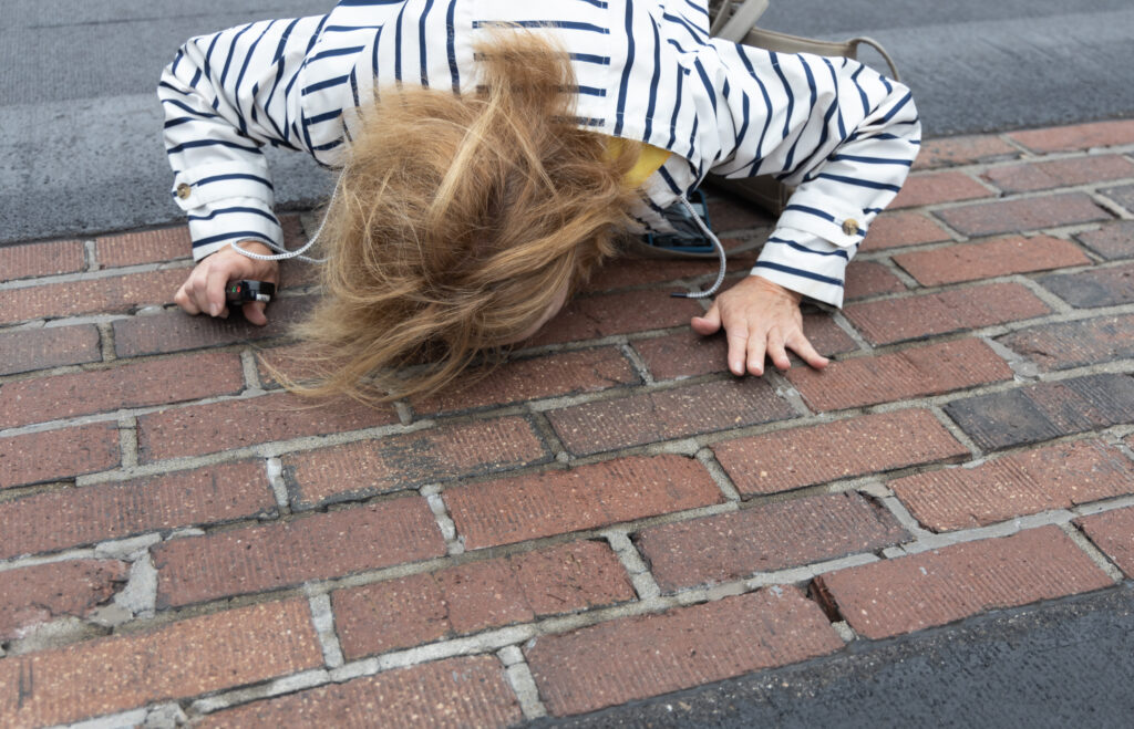 Someone kissing the bricks at the start-finish line of the Indianapolis Motor Speedway oval