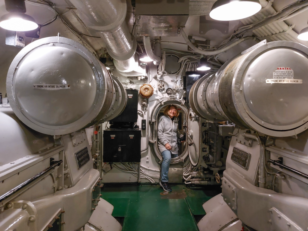 Connie climbing through a hatch on the USS Drum submarine