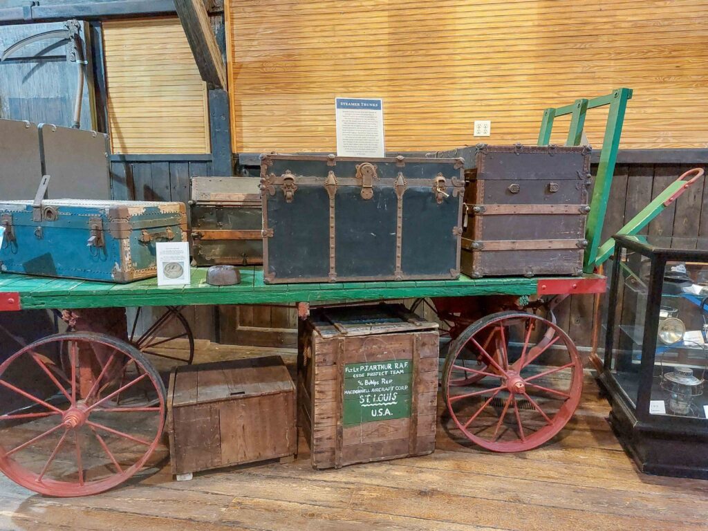 Antique baggage cart with a steamer trunk on it