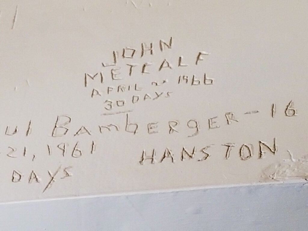 Graffiti left near the old jail upstairs in Boot Hill Distillery