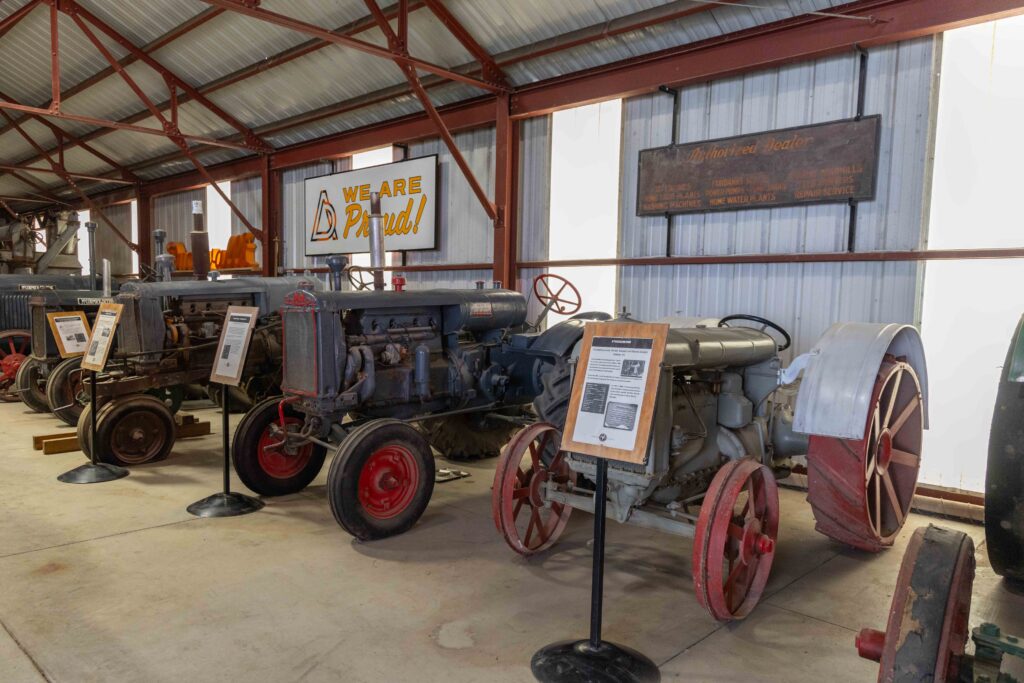 A row of antique farm tractors
