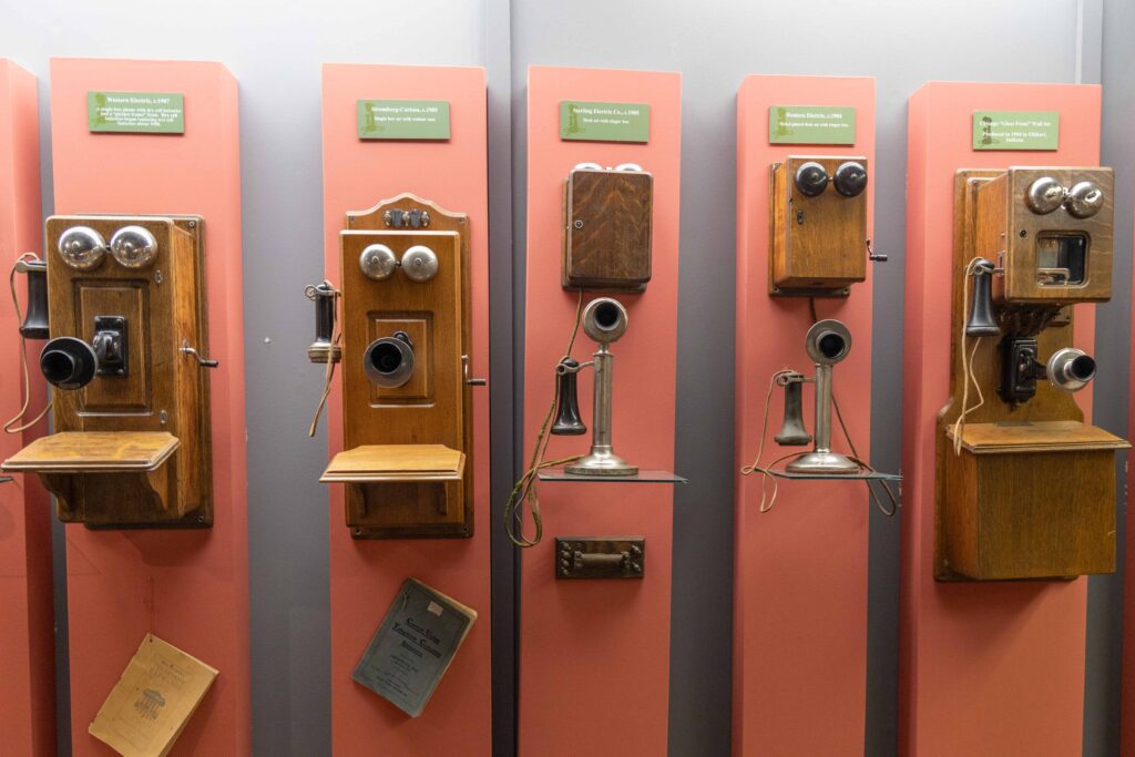 A row of five old-fashioned telephones