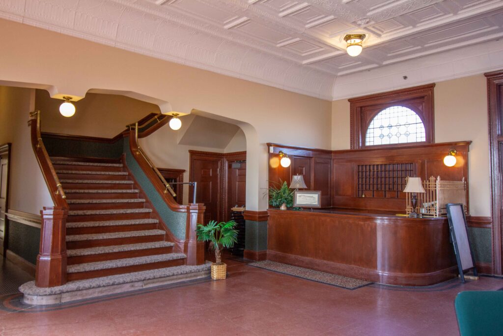 Wide Staircase and old wooden hotel registration desk