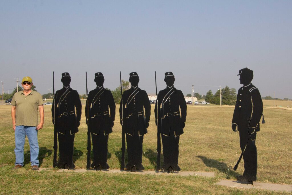 Silhouette figures of soldiers and Skip standing with them