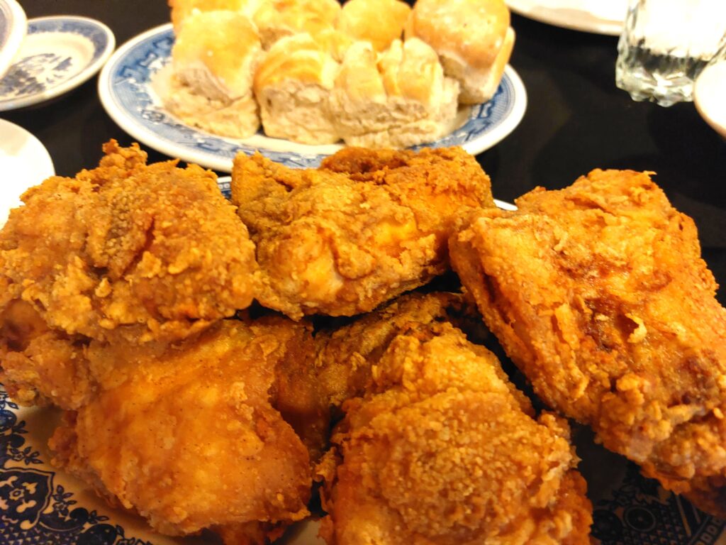 Plates of fried chick and rolls